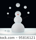 Felt snowman juggles woolen Christmas snowballs at 95816121