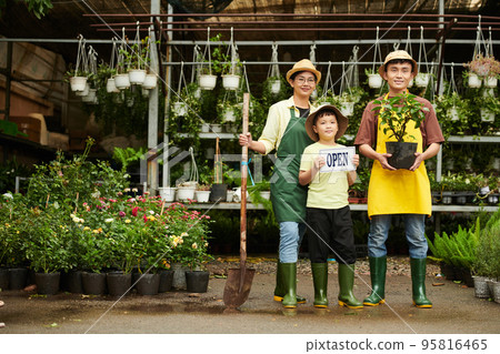 Happy family of three opening plant nursery 95816465