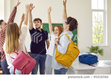 High school students rise hands up at classroom. 95816560