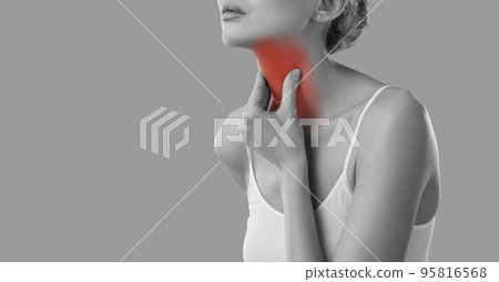 Young sick woman feels pain because of sore throat or because of thyroid problems. 95816568