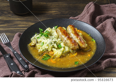 Dutch stamppot of potatoes, kale and sausages on plate 95816673