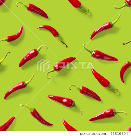Seamless pattern made of red chili or chilli on green background. Minimal food pattern. Red hot chilli seamless peppers pattern. Food background. 95816804
