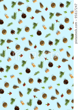 christmas background with pine cone, wine cork, pine twig and lingonberry. christmas background on blue backdrop. christmas background with pine cone, wine cork, pine twig and lingonberry. christmas background on blue backdrop. 95817247