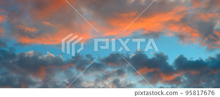 Sun rays in colorful clouds . Wide photo. 95817676