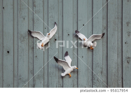 decorative seagulls on the wooden facade of barn in Denmark 95817954