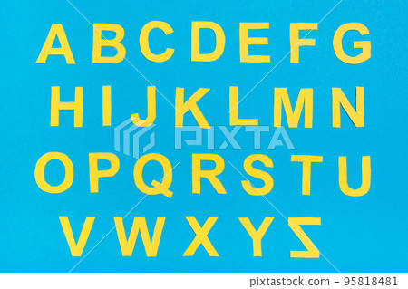 The letters of the English alphabet are cut out of yellow cardboard on a blue background The letters of the English alphabet are cut out of yellow cardboard on a blue background 95818481