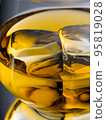 Glass of whisky with ice cubes, close-up shot 95819028