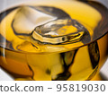 Glass of whisky with ice cubes, close-up shot 95819030