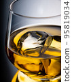 Glass of whisky on the rocks 95819034