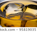 Glass of whisky with ice cubes, close-up shot 95819035