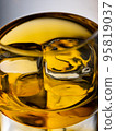 Glass of whisky with ice cubes, close-up shot 95819037