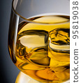 Glass of whisky with ice cubes, close-up shot 95819038