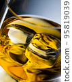 Glass of whisky with ice cubes, close-up shot 95819039