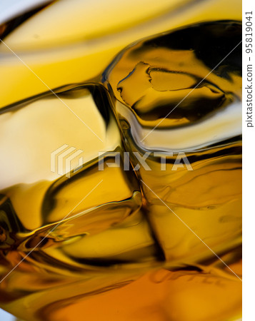 Glass of whisky with ice cubes, close-up shot 95819041