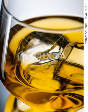 Glass of whisky with ice cubes, close-up shot 95819042