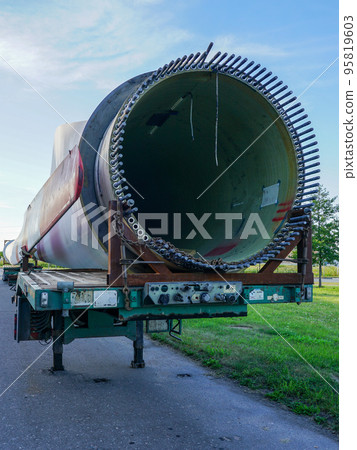 Low-loader semi-trailer with oversized wind generator parts in the parking lot 95819603