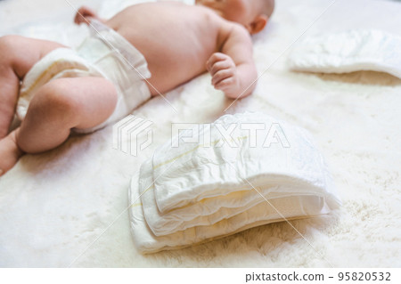 Diaper change newborn kid banner. Happy cute infant baby in nappy. Child care white background. Newborn care, colic, teeth, newborn day regimen. Diaper change newborn kid banner. Happy cute infant baby in nappy. Child care white background. Newborn care, colic, teeth, newborn day regimen. 95820532