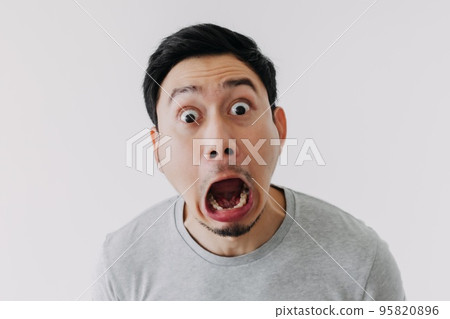 Funny shocked surprised closeup face man isolated on white background. 95820896