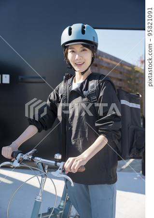 Food delivery image A young woman delivering food by bicycle Shared delivery 95821091