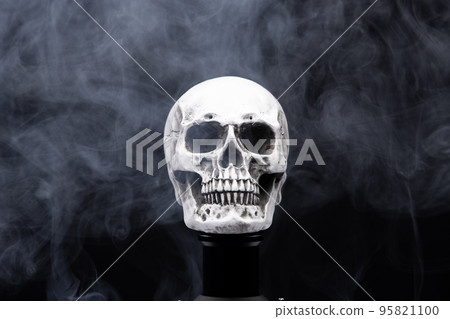 Halloween human skull on an old table over black background. Shape of skull bone for Death head on halloween festival which show horror evil tooth fear and scary, copy space 95821100
