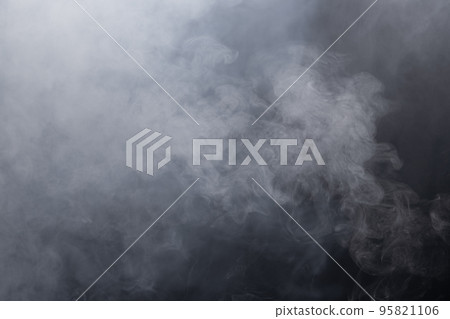 Dense Fluffy Puffs of White Smoke and Fog on black Background, Abstract Smoke Clouds, Movement Blurred out of focus. Smoking blows from machine dry ice fly fluttering in Air, effect texture 95821106