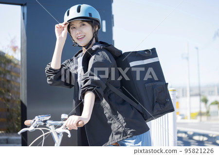 Food delivery image A young woman delivering food by bicycle Shared delivery 95821226
