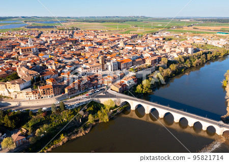 Aerial view on old stone bridge of Douro river and old town Tordesillas. Spain Aerial view on old stone bridge of Douro river and old town Tordesillas. Spain 95821714