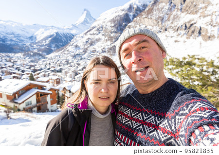 Happy couple taking selfie on background of mountains while traveling together 95821835