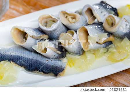 Salted pickled herring fish served on a ceramic plate 95821881