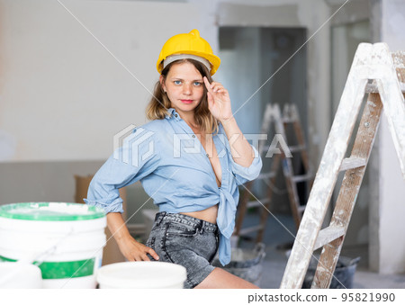 Tempting woman in revealing attire posing in construction site 95821990