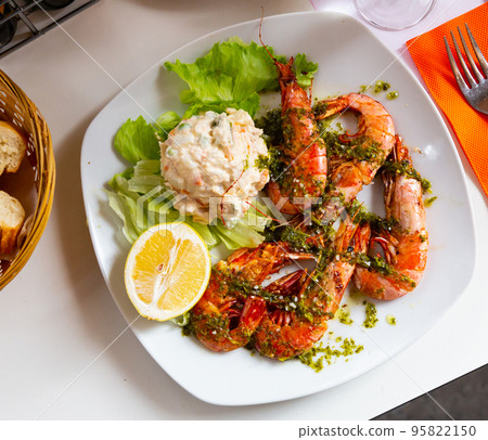 Tasty king shrimps, served with lettuce and salad from potatoes Tasty king shrimps, served with lettuce and salad from potatoes 95822150