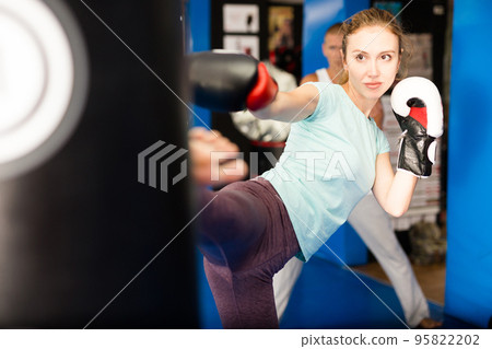 Blonde woman punchbag in gym 95822202