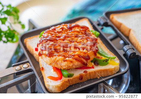 Bread topped with ham cutlet served with sauce 95822877