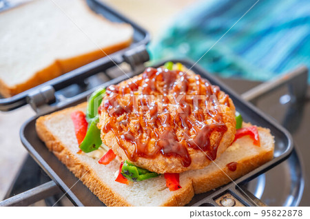Bread topped with ham cutlet served with sauce 95822878