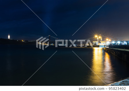 10-29-2022 LISBON, PORTUGAL: The 25 de Abril Bridge At Night 10-29-2022 LISBON, PORTUGAL: The 25 de Abril Bridge At Night 95823402
