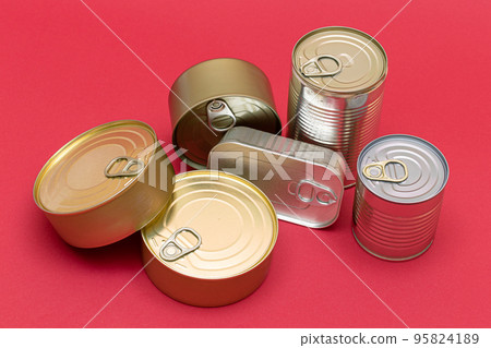 Unopened Tin Cans with Blank Edges on Red Background Unopened Tin Cans with Blank Edges on Red Background 95824189