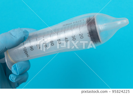 Anti Vaccination Concept - Syringe in a Condom Anti Vaccination Concept - Syringe in a Condom 95824225