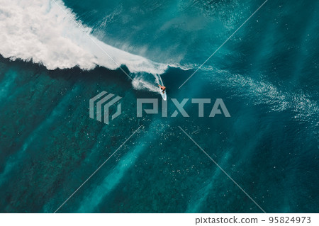 Aerial view with surfing on wave. Perfect waves with surfers in ocean Aerial view with surfing on wave. Perfect waves with surfers in ocean 95824973