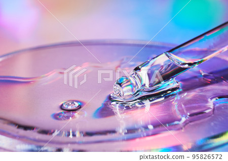 Pipette with sample of cosmetic product in petri dish on holographic background, iridescent highlights, selective focus 95826572