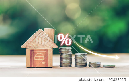 House and coins place on the wood table is ladder with white illustration shows decreasing of interest rates. House and coins place on the wood table is ladder with white illustration shows decreasing of interest rates. 95828625