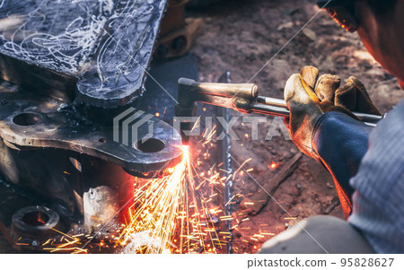 Close up hand heavy industrial worker is working on metal work factory process by Cutting sheet 95828627