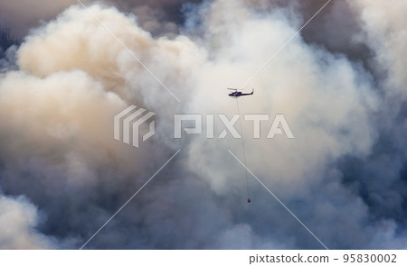 Wildfire Service Helicopter flying over BC Forest Fire and Smoke on the mountain near Hope Wildfire Service Helicopter flying over BC Forest Fire and Smoke on the mountain near Hope 95830002