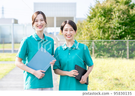 A female care manager working at a facility in a uniform 95830135