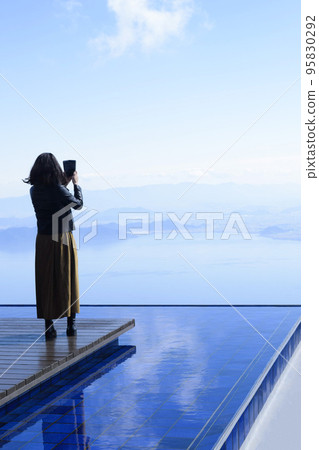 A woman taking a picture on the Biwako Terrace, the view of Lake Biwa from the Biwako Terrace 95830292