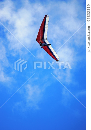 Paraglider on a Blue Sky 95832319