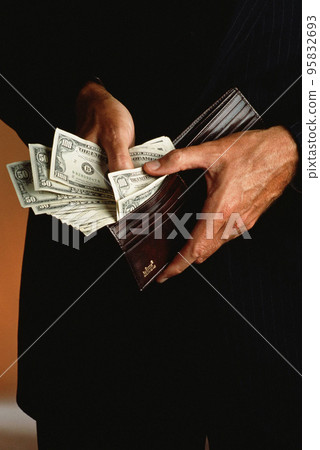 Wallet with dollars in the hands 95832693
