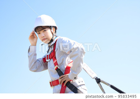 Female worker wearing full harness Work at height Construction site Image 95833495