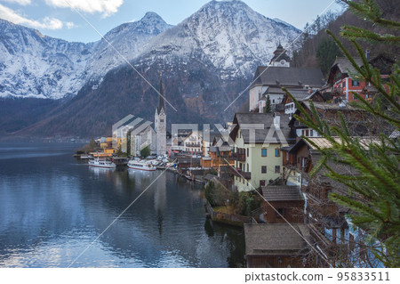 Hallstatt, a charming village on the Hallstattersee lake and a famous tourist attraction, with beautiful mountains surrounding it, in Salzkammergut region, Austria, in winter sunny day. Hallstatt, a charming village on the Hallstattersee lake and a famous tourist attraction, with beautiful mountains surrounding it, in Salzkammergut region, Austria, in winter sunny day. 95833511