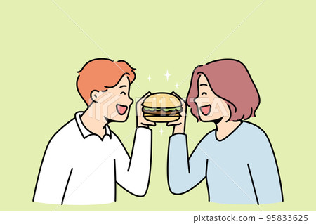 Happy couple eating burger together 95833625