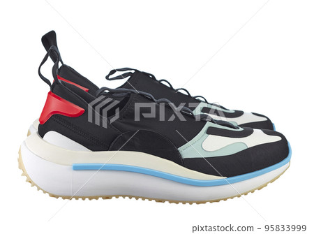 Side view fashionable sneakers made of a combined color texture, on a bright colored sole, with lacing, isolated on a white background. 95833999